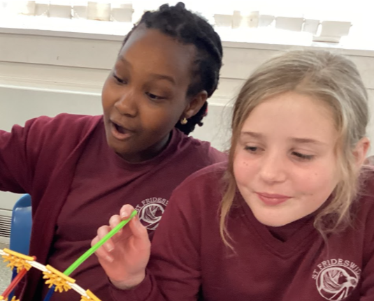 two children playing with modelling equipment